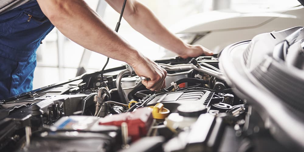 Photo of mechanic servicing a vehicle